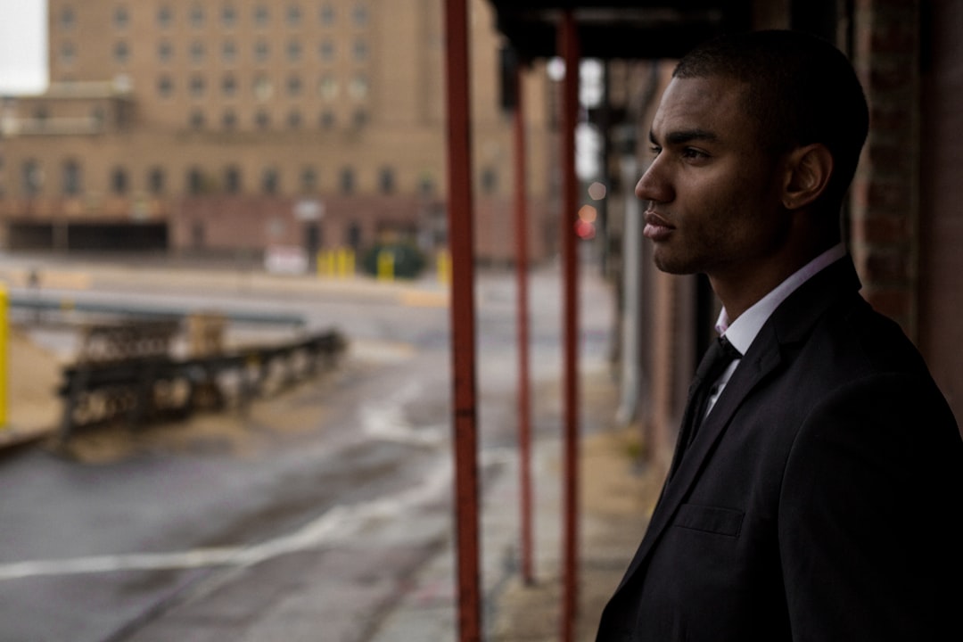 An expert in a sleek, modern office looks out over a sprawling city skyline, symbolizing forward-thinking predictions for the future of real estate.