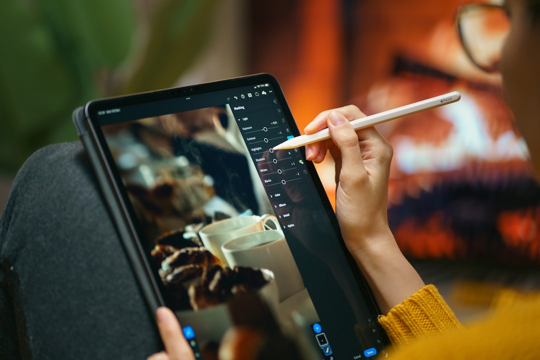 Real estate professional using a tablet in a bright, modern home, illustrating the integration of AI and smart technology ...
